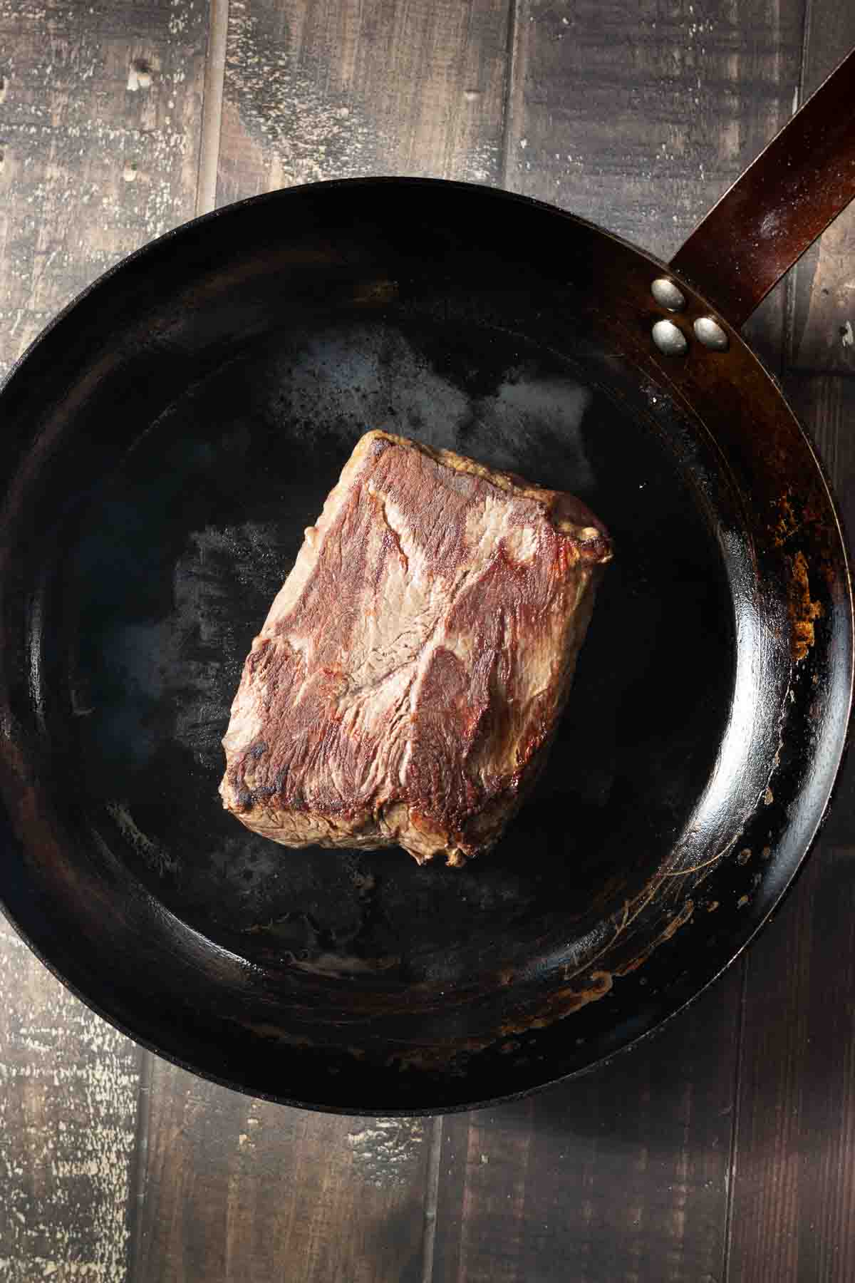 Pan seared merlot steak in a carbon steel pan.