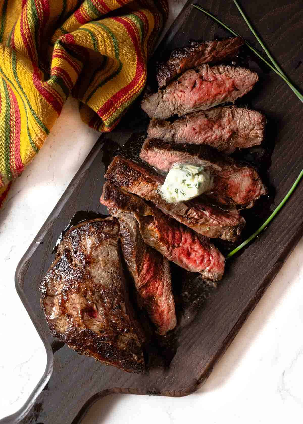 Pan seared sliced Merlot steak topped with blue cheese butter.