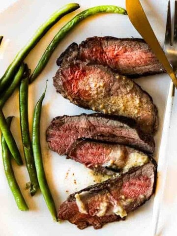 Pan Fried Baseball Top Sirloin steak served with green beans.