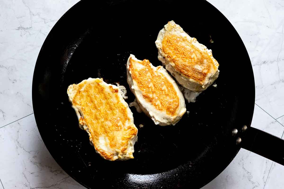 Pan searing chicken breasts to make rattlesnake pasta.