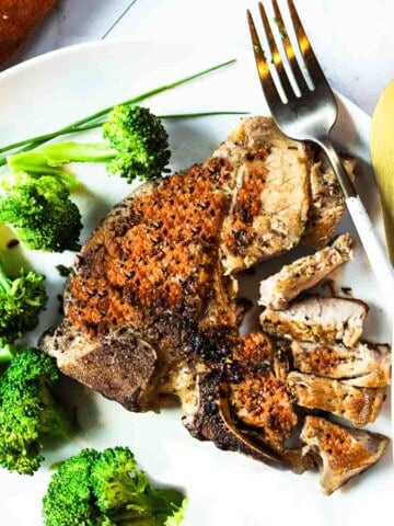 Pan seared veal loin chops served with broccoli.