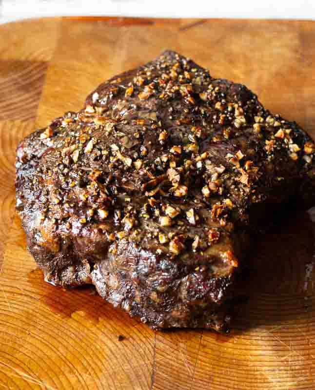 Step 4: A cooked chuck eye roast out of the oven and on a cutting board.