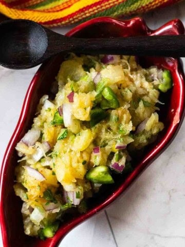 Jalapeno pineapple salsa in a red chile shaped serving bowl.