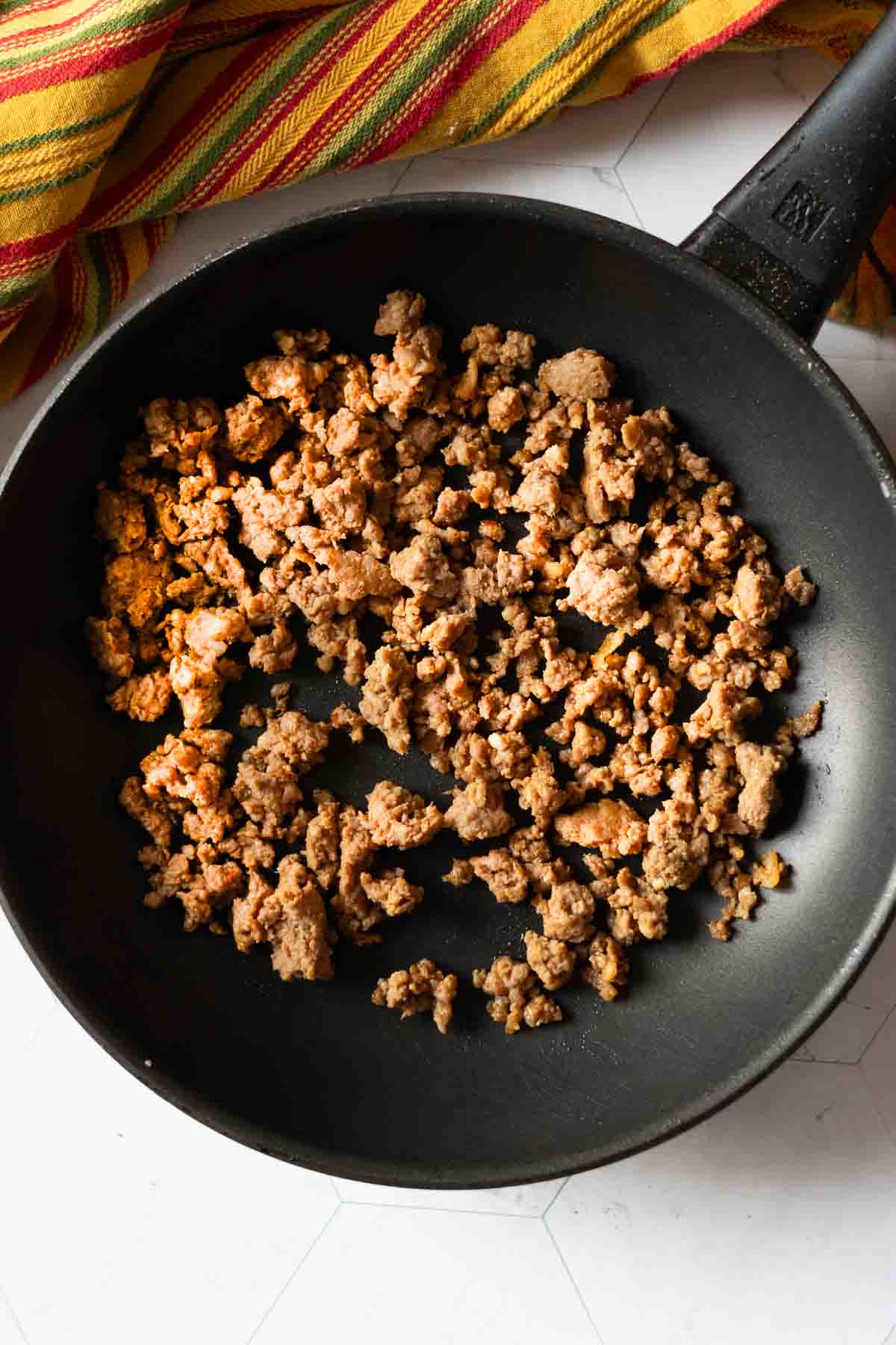 Step 2: Browning chorizo sausage to make a chorizo breakfast burrito.