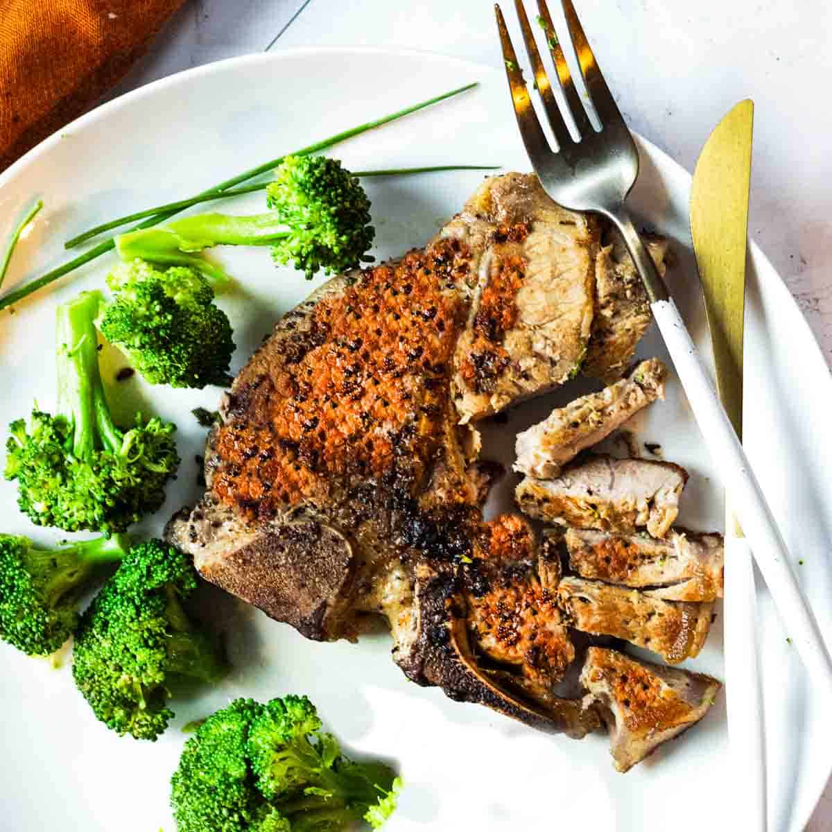 Pan seared veal chops served with broccoli florettes.