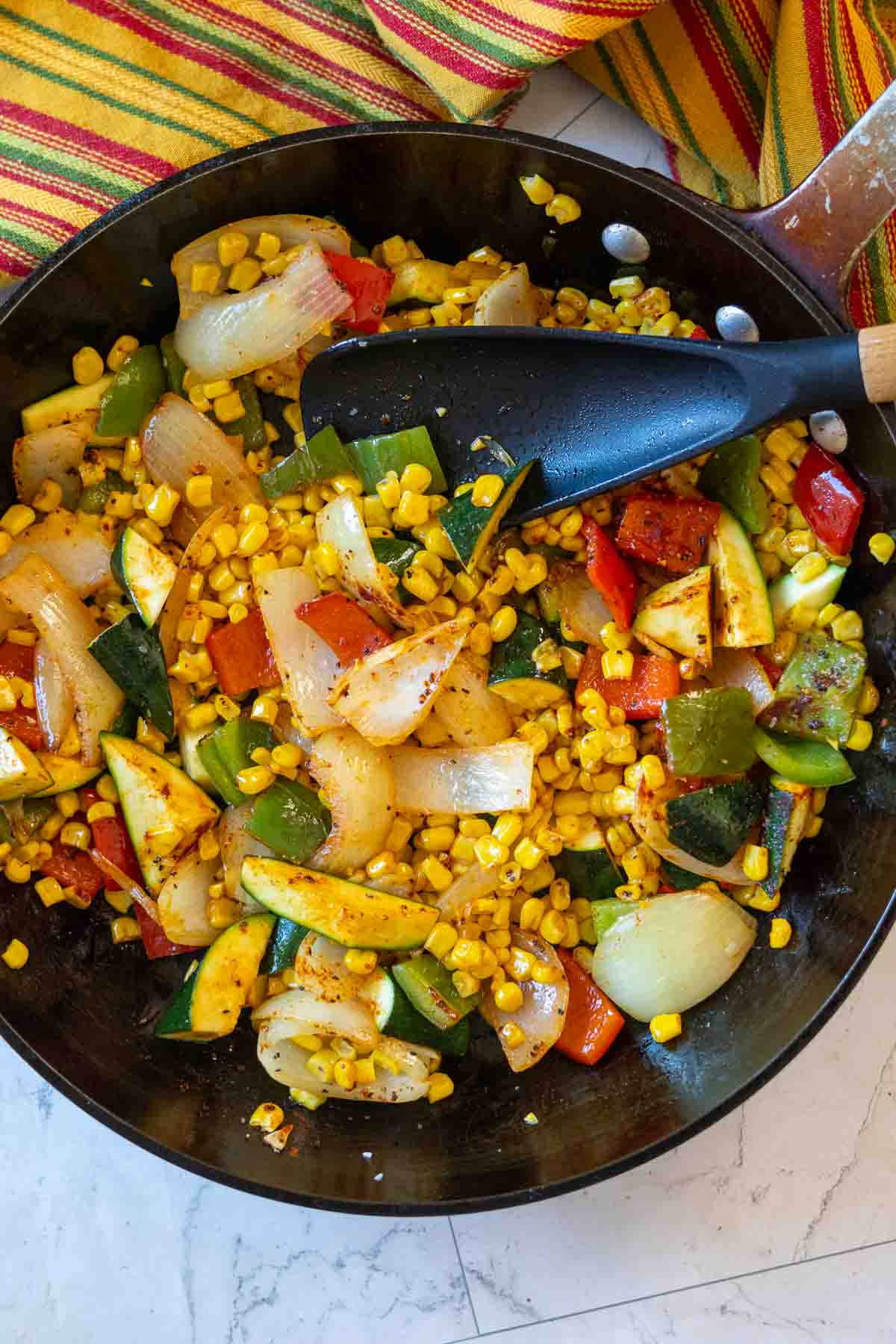 Step 4: Stirring in spices for Southwestern sauteed mixed vegetables.