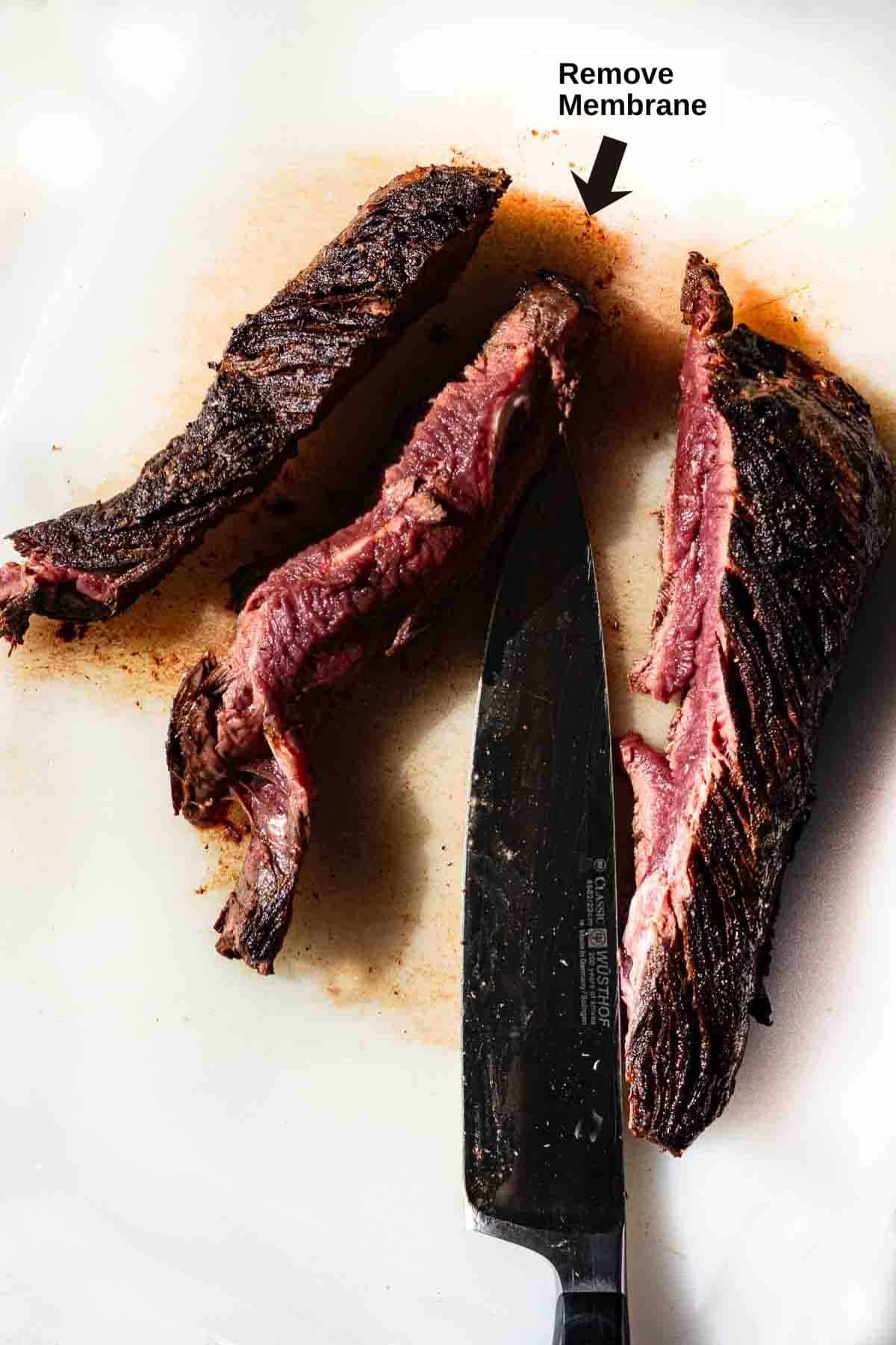 Step 2: Removing membrane from cooked hanging tender steak.
