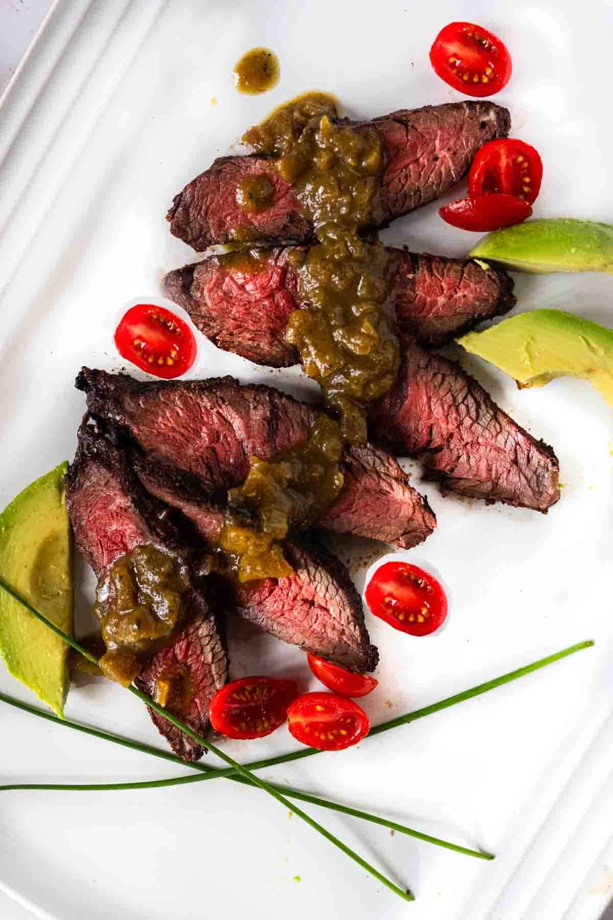 Hanging tender steak drizzled with green chile sauce.