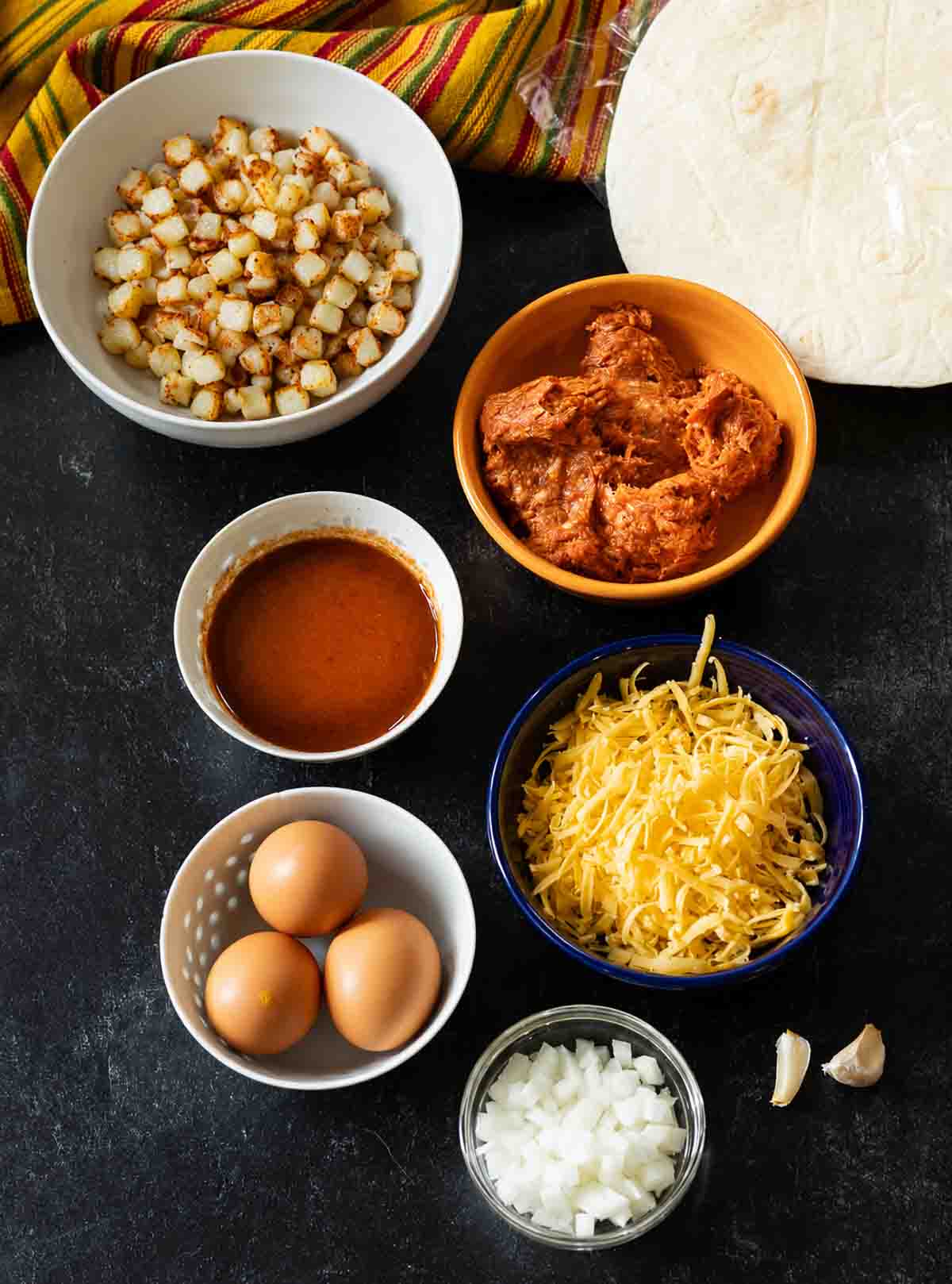 Ingredients to make chorizo breakfast burritos with potatoes and eggs.